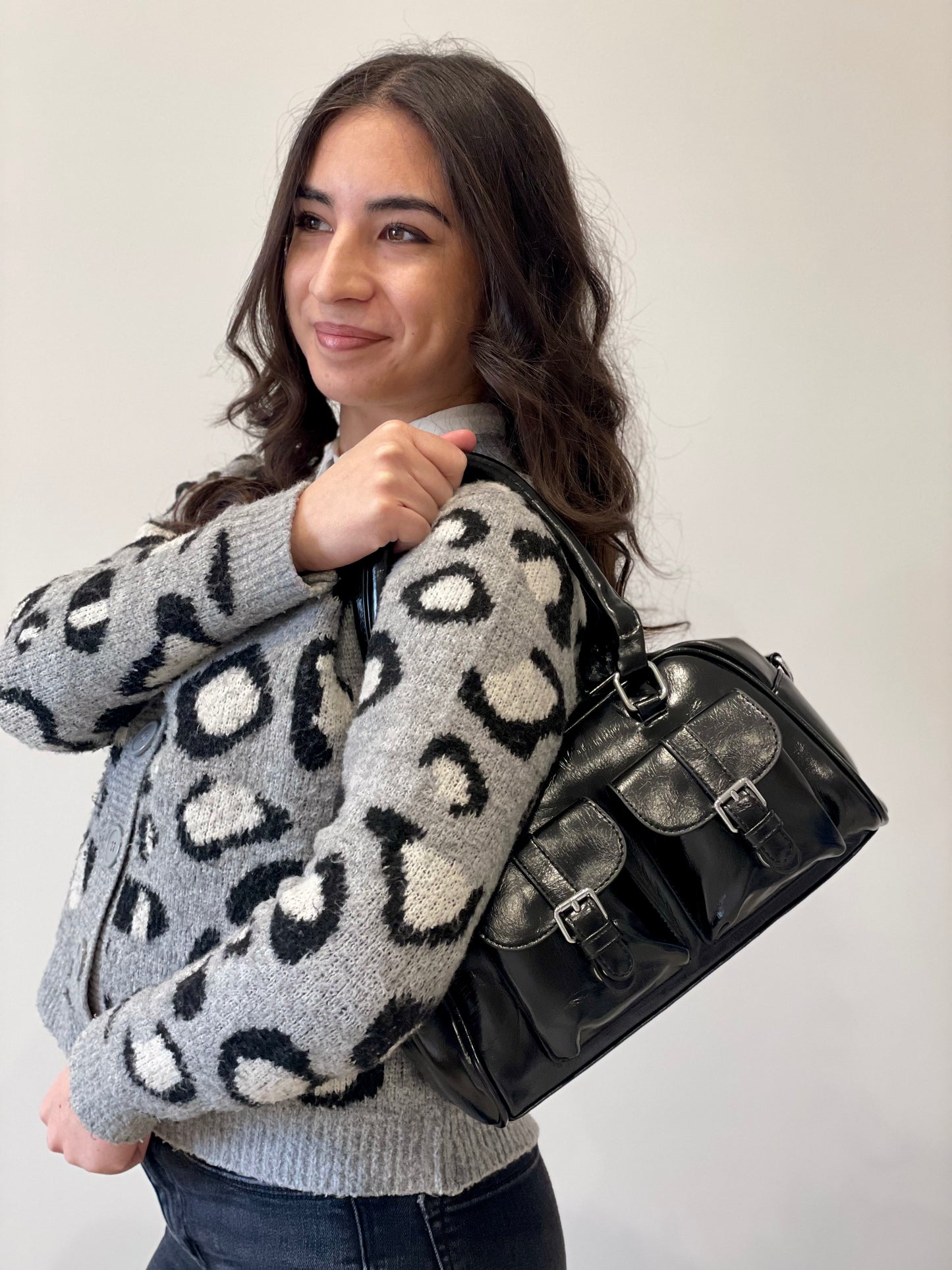 Borsa Syndey bauletto lucido nero con tasche frontali indossato